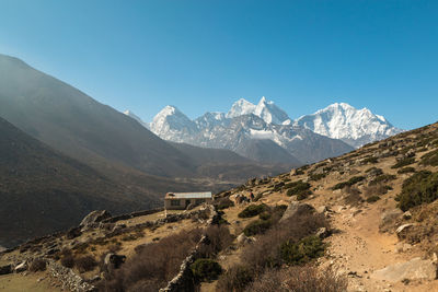 Scenic view of mountains against clear blue sky