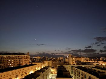 High angle view of illuminated buildings against sky at night