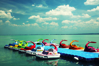 Boats moored in sea against sky