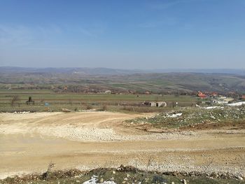 Scenic view of agricultural field against blue sky