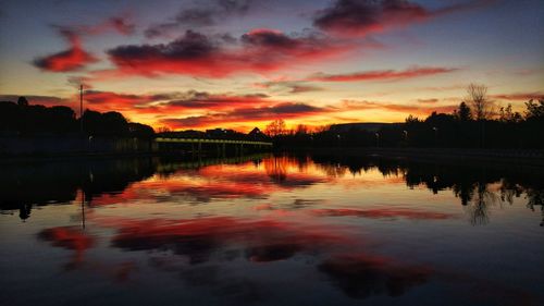 Scenic view of lake against orange sky