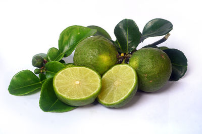Close-up of green fruits against white background