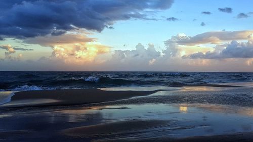 Scenic view of beach against sky during sunset