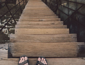 Two feet on top of stairs 