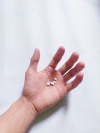 Cropped hand holding medicines