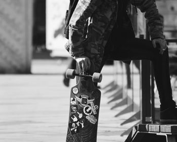 Low section of man walking on railing