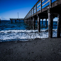 Pier over sea against clear sky
