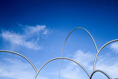 Low angle view of metal fence against sky