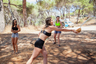 Women playing with water outdoors