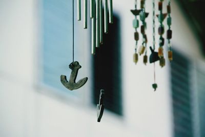Close-up of chain hanging on window