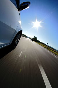 Car on road against sky during sunset