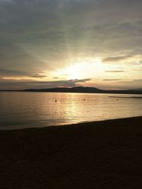 View of sea against cloudy sky during sunset