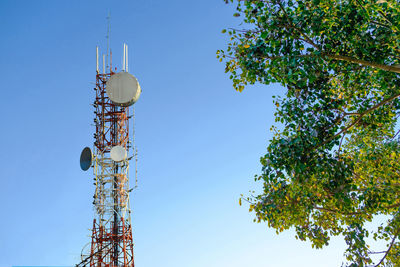 Low angle view of communications tower against sky