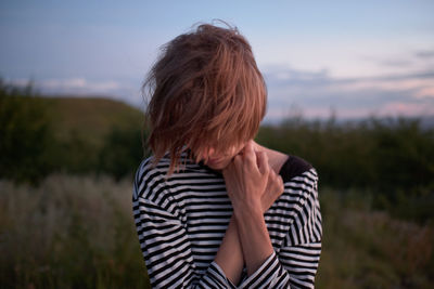 Woman standing on land against sky