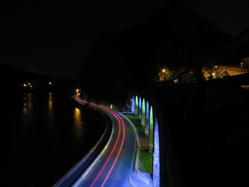 Light trails on road in city at night