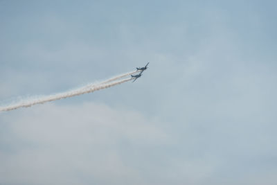 Low angle view of airshow against sky