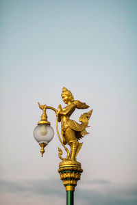 Low angle view of angel statue against sky