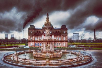 City skyline against cloudy sky