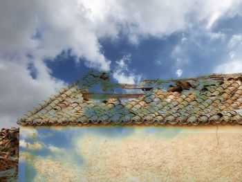 Low angle view of roof and building against sky