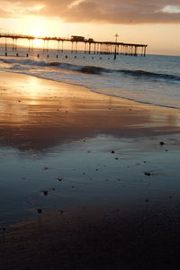 Scenic view of beach against sky during sunset