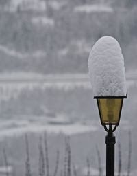 Close-up of frozen snowcapped lamp during winter