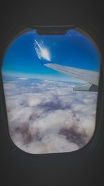 Aerial view of clouds seen through airplane window