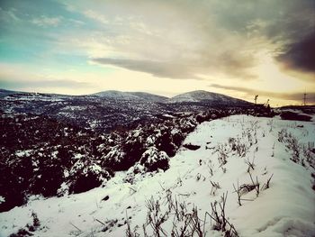 Scenic view of mountains against cloudy sky