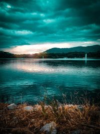 Scenic view of lake against cloudy sky