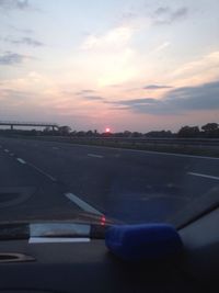 Car on road at sunset