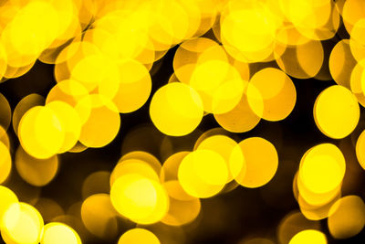 Close-up of yellow lights at night