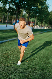 Full length of young man sitting on grass