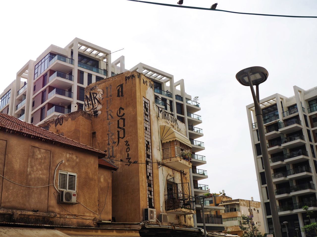 LOW ANGLE VIEW OF RESIDENTIAL BUILDINGS AGAINST SKY