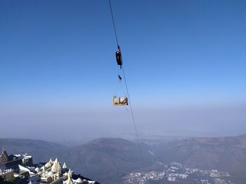 Overhead cable cars against mountain range