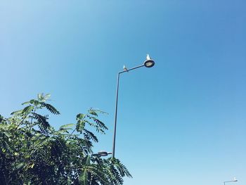 Low angle view of street light against clear blue sky