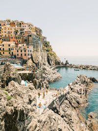 Scenic view of sea by buildings against sky