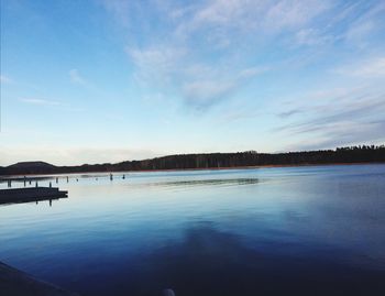 Scenic view of lake against cloudy sky