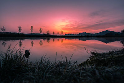 Scenic view of lake against romantic sky at sunset