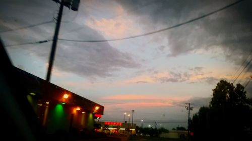 Street light against cloudy sky