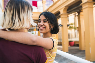 Close-up of lesbian couple romancing while standing in city