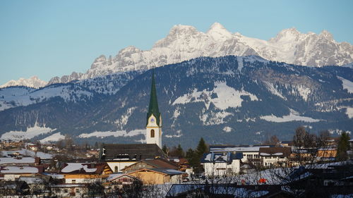 High angle view of townscape and mountains against sky