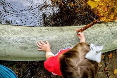 High angle view of girl by pond at park