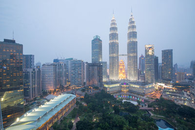 Petronas towers against sky in city