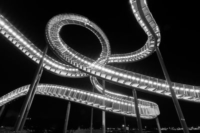 Low angle view of illuminated ferris wheel at night