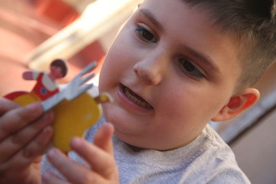 Close-up of boy eating food at home