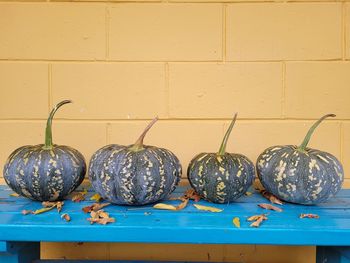 Various fruits on table against wall