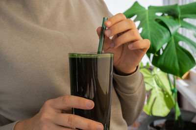 Midsection of woman holding drink