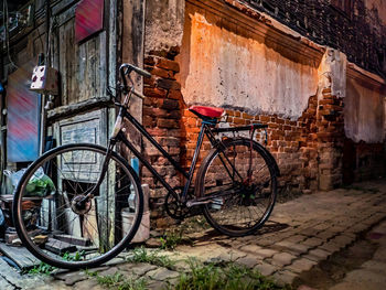 Bicycle parked against building