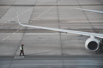 Ground crew walking at airport runway