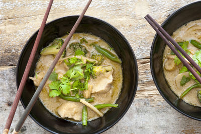 High angle view of curry in bowls on table