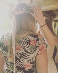 Rear view of girl holding flowers